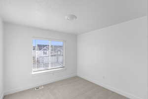 Bedroom 3 with light carpet