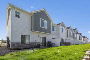 Rear view of house featuring a yard