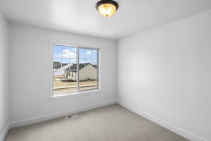 View of carpeted spare room