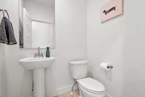 Bathroom with pedestal sink and toilet off of the great room