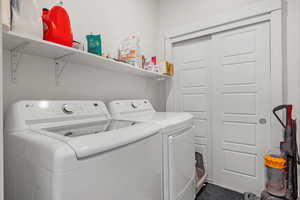 Walk in Laundry room with shelf and storage closet