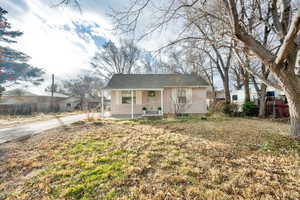 Bungalow-style house featuring a porch and a front lawn