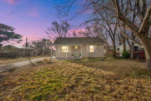 View of front of house featuring a porch and a yard