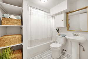 Full bathroom featuring shower / bathtub combination with toilet, and sink