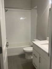 Full bathroom featuring vanity, toilet, and tiled shower / bath combo