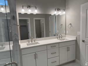 Owners Bathroom with vanity, toilet, and a shower with shower door