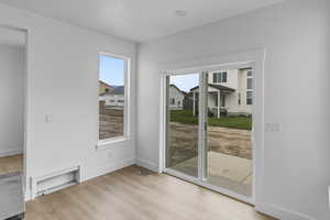 Doorway with light hardwood / wood-style flooring