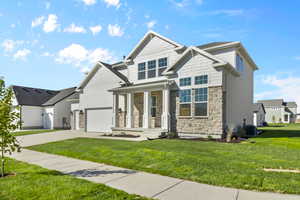 Craftsman-style house featuring a front yard, covered porch, and central air condition unit