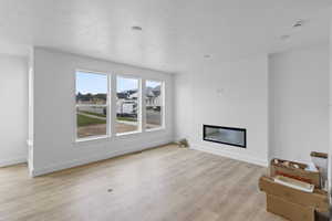 Unfurnished living room featuring light wood-type flooring