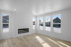 Unfurnished living room featuring light wood-type flooring