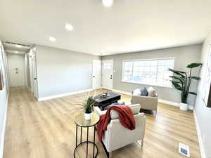 Living room with light wood-type flooring