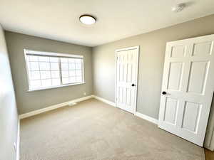 Unfurnished bedroom featuring carpet and a closet