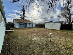 View of yard featuring a storage shed and central AC unit