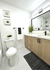 Bathroom featuring vanity, toilet, and tile patterned flooring