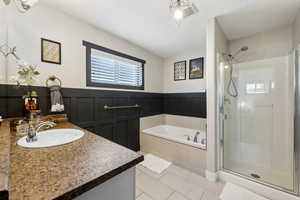 Bathroom with plus walk in shower, tile patterned floors, and vanity