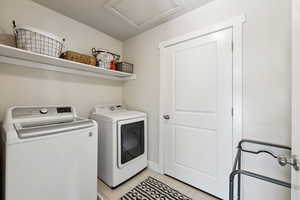 Washroom featuring separate washer and dryer and light tile patterned floors