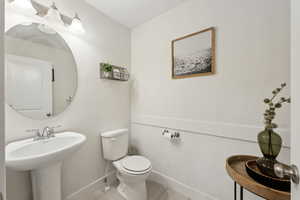 Bathroom featuring sink, tile patterned floors, and toilet