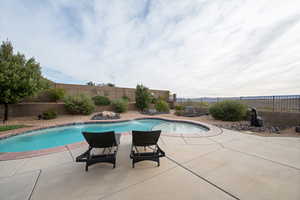 View of swimming pool with a patio and pool water feature