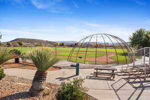 Surrounding community with a rural view, a mountain view, and a lawn