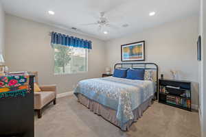 Carpeted bedroom with ceiling fan