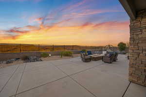 Patio terrace at dusk featuring an outdoor living space with a fire pit