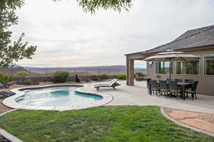 View of swimming pool featuring a yard and a patio