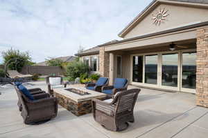 View of patio / terrace with a fire pit and ceiling fan