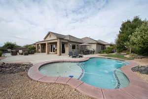 View of swimming pool featuring a patio area and pool water feature