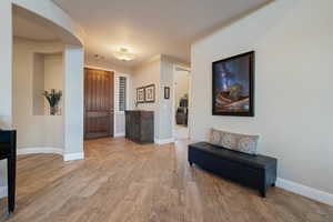 Entrance foyer with light wood-type flooring