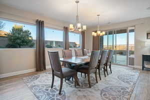 Dining space featuring light hardwood / wood-style floors and a notable chandelier