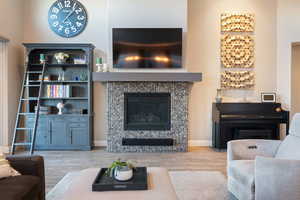 Living room with a fireplace and light hardwood / wood-style floors