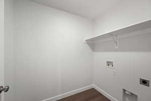 Laundry room with hookup for a washing machine, hookup for an electric dryer, and dark hardwood / wood-style flooring