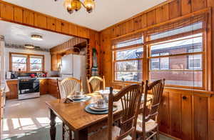 Dining room featuring crown molding and wood walls