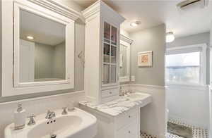 Updated athroom with double sinks, ample cupboards and storage