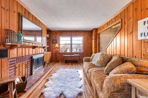 Living room with brick fireplace and built in bookshelves.