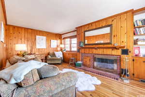 Living room features crown molding, fireplace, and hardwood flooring