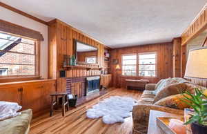 Living room features a fireplace, knotty pine walls, and original hardwood flooring.