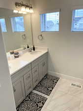 Bathroom with vanity and a chandelier