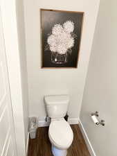 Bathroom with hardwood / wood-style flooring and toilet