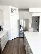 Kitchen featuring backsplash, dark hardwood / wood-style floors, stainless steel fridge with ice dispenser, and grey cabinets