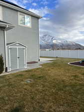 View of yard featuring a mountain view and a storage unit