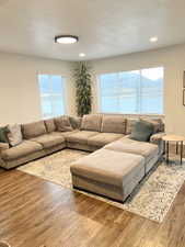 Living room featuring hardwood / wood-style flooring and a textured ceiling