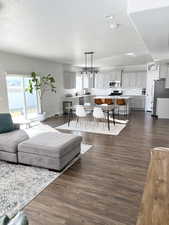 Living room with dark hardwood / wood-style flooring and a textured ceiling