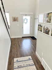 Entrance foyer with dark hardwood / wood-style flooring