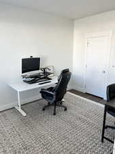 Office space featuring dark wood-type flooring