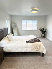 Carpeted bedroom featuring a textured ceiling