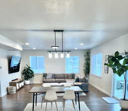 Living room featuring dark hardwood / wood-style floors and a textured ceiling