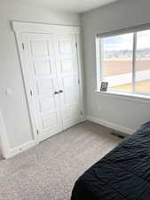 Carpeted bedroom featuring a closet