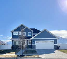 Craftsman-style house featuring a garage and a mountain view