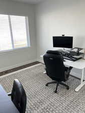 Office with dark hardwood / wood-style floors